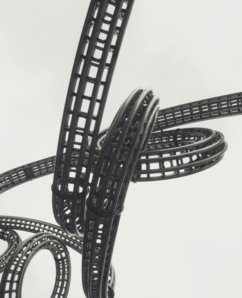 Close-up of roller coaster tracks crossing overhead